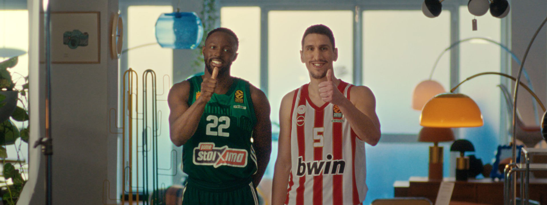 2 basketball players in team jerseys