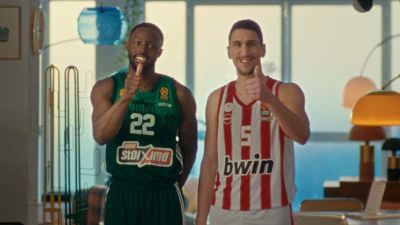2 basketball players in team jerseys