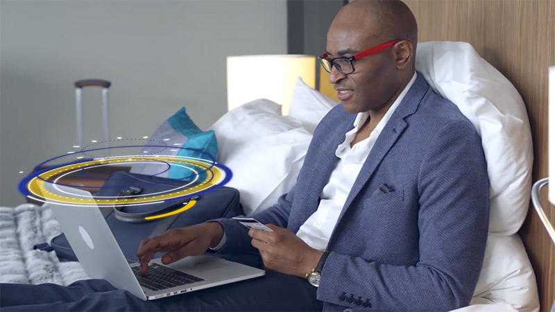 man using laptop on bed