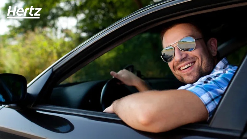 man inside a car looking out the window